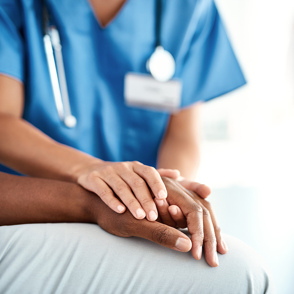 nurse holding patients hand